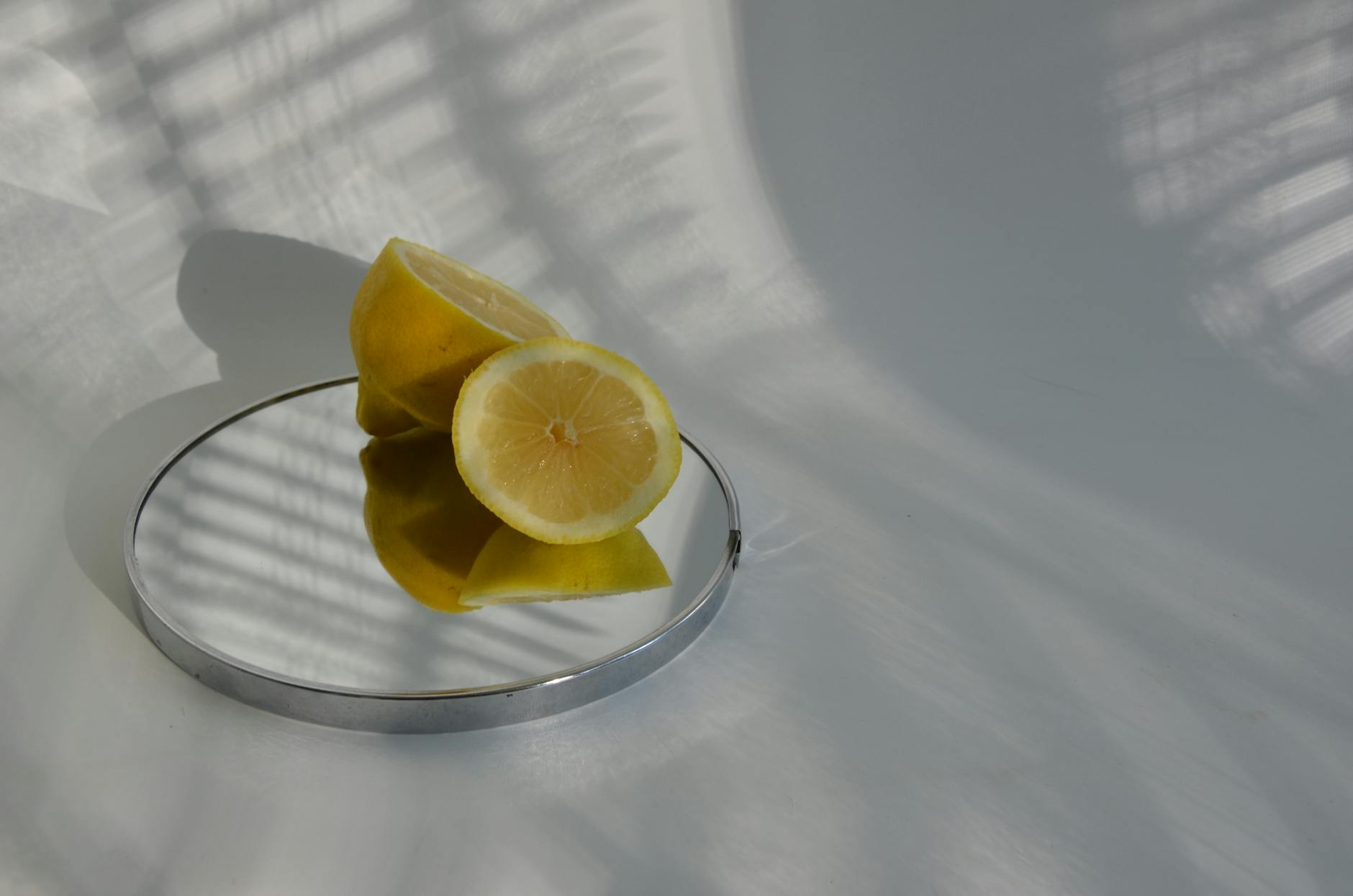 A teal lemon vibrator on smooth white silk fabric